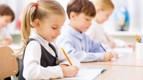 students writing on their desks